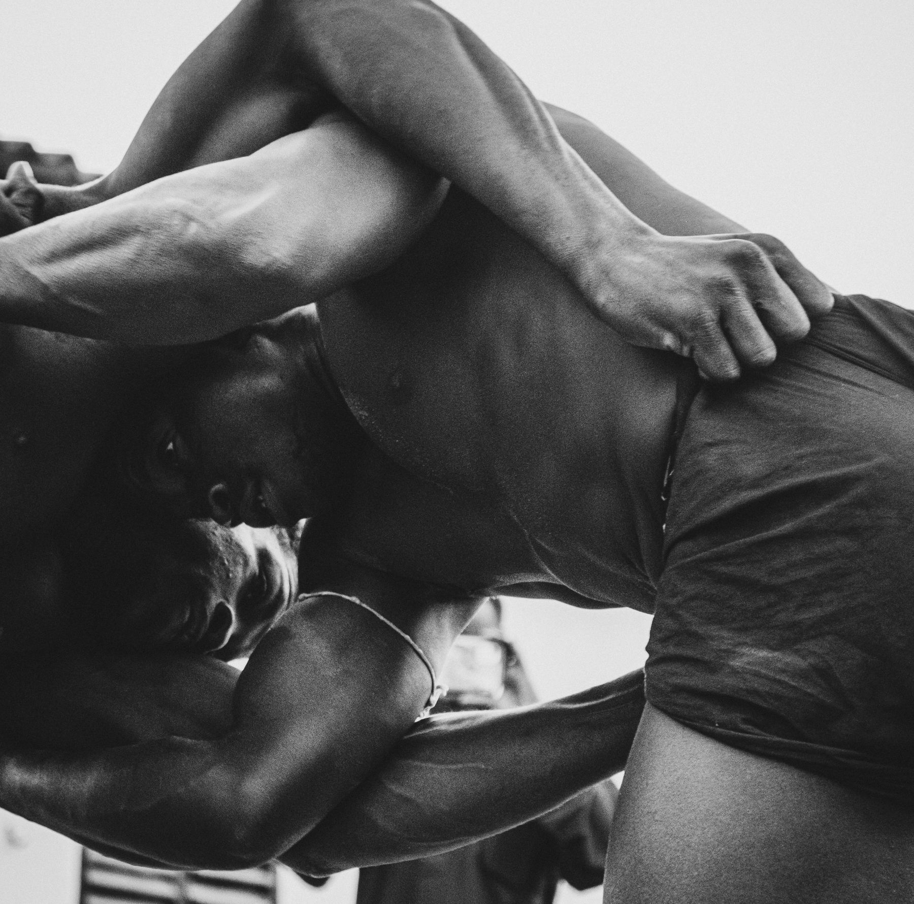 Close-up of two wrestlers gripping each other, shot from below